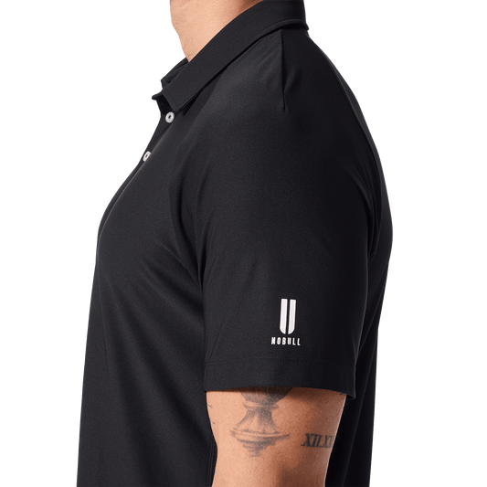 Men's Black NOBULL All Fore It Polo Shirt Side U NOBULL Logo Angle.