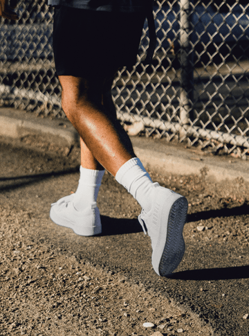 Man running wearing Recs Knit shoes.