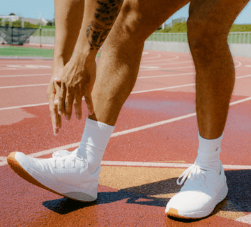Man on track wearing allday ripstop shoes.