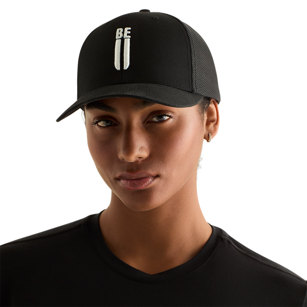 Woman Wearing Black Be U Trucker Hat Front Angle.