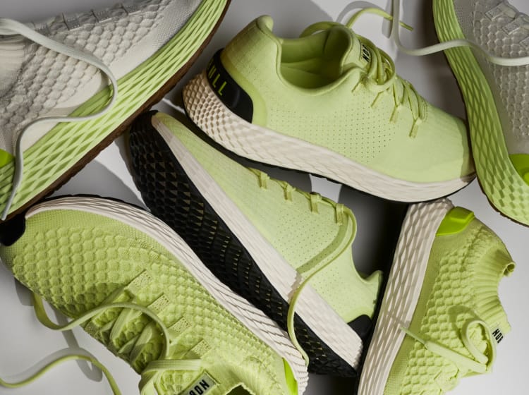 Green and black athletic shoes on a white background