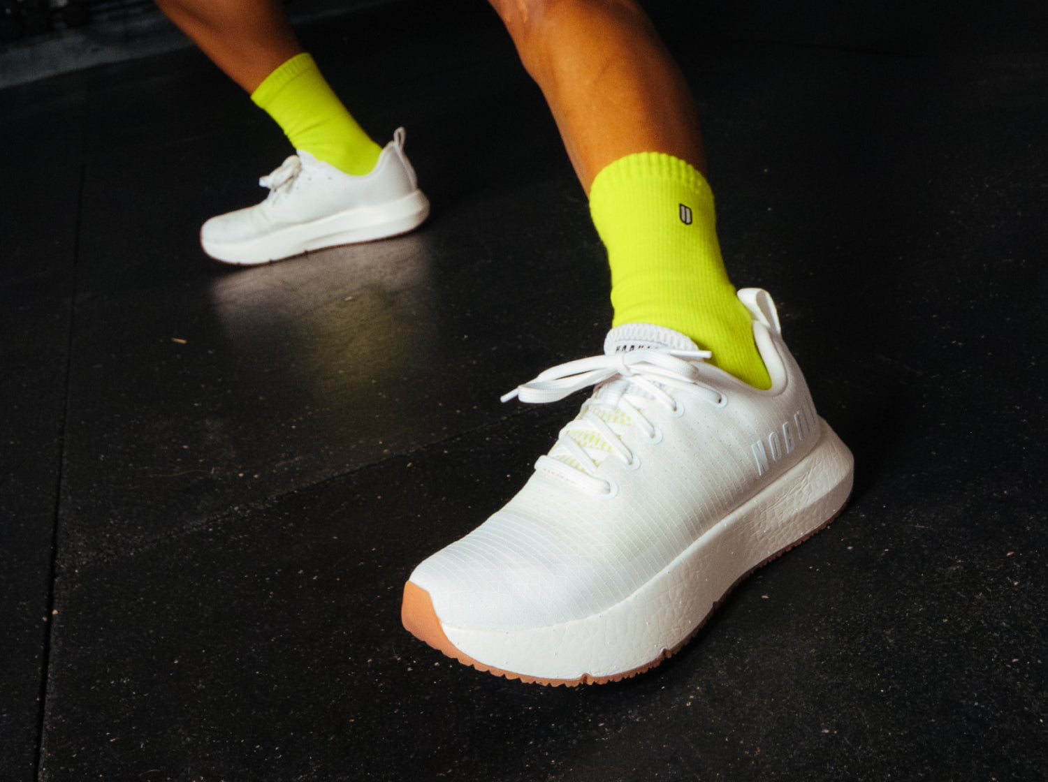 White Drive Ripstop with yellow socks on a dark floor