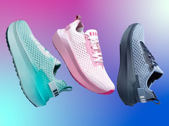 product - Three mesh athletic sneakers floating against a blue-to-pink gradient background: a mint green and black shoe, a white and pink shoe, and a gray and black shoe.