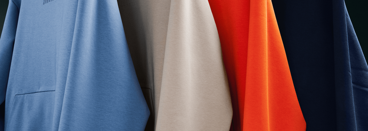 promo - different colored sweatshirts hanging from a rack.
