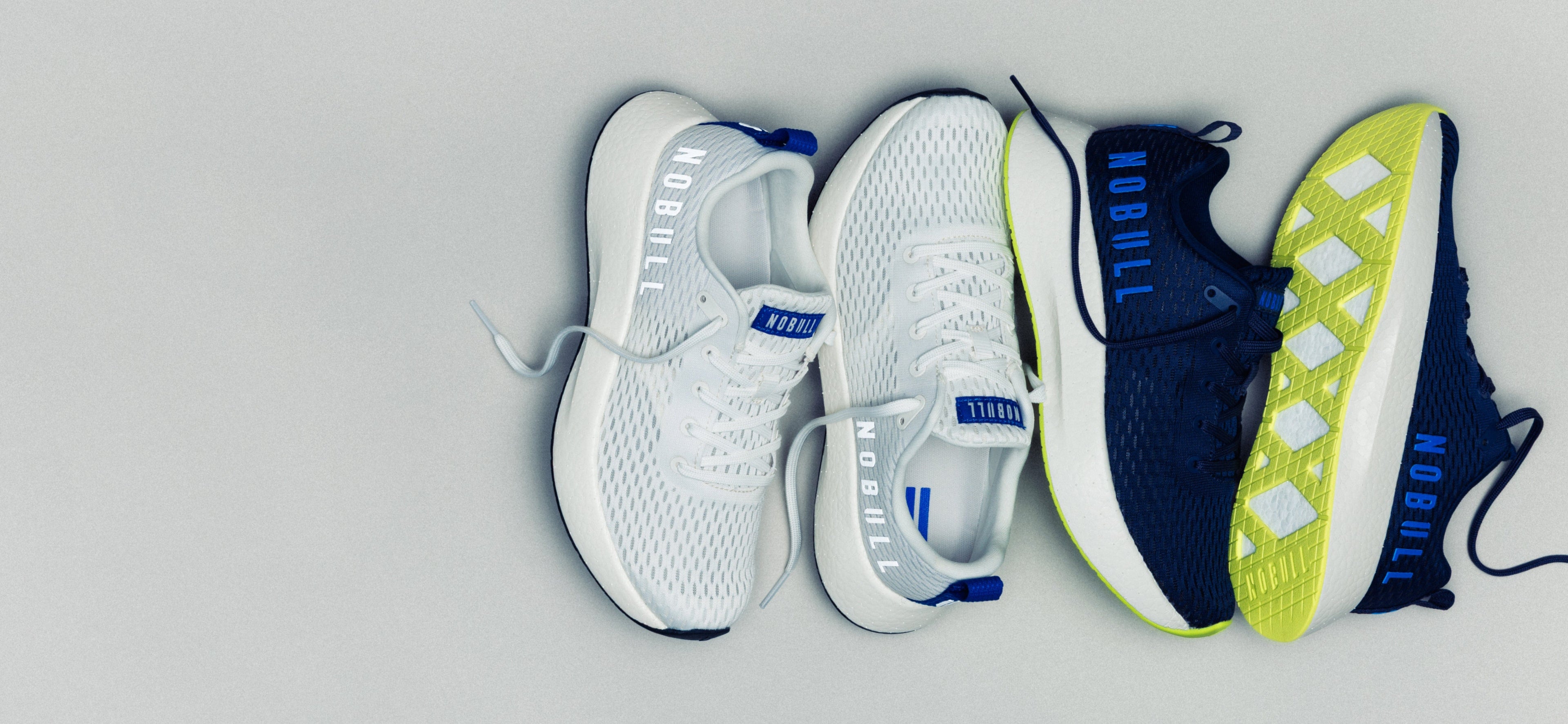 Three pairs of running shoes on a gray background