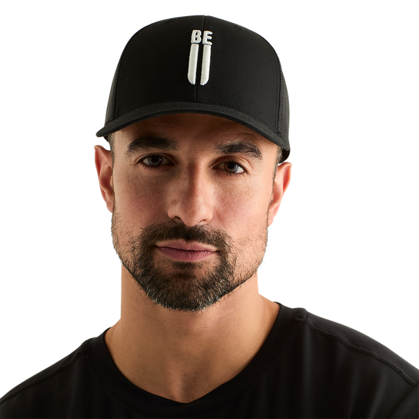 Man Wearing Black Be U Trucker Hat Front Angle.