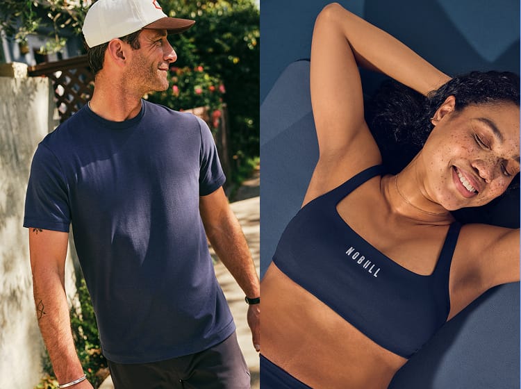 Woman wearing a navy blue sports bra with 'NOBULL' branding, and a man walking outdoors wearing a navy blue t-shirt.
