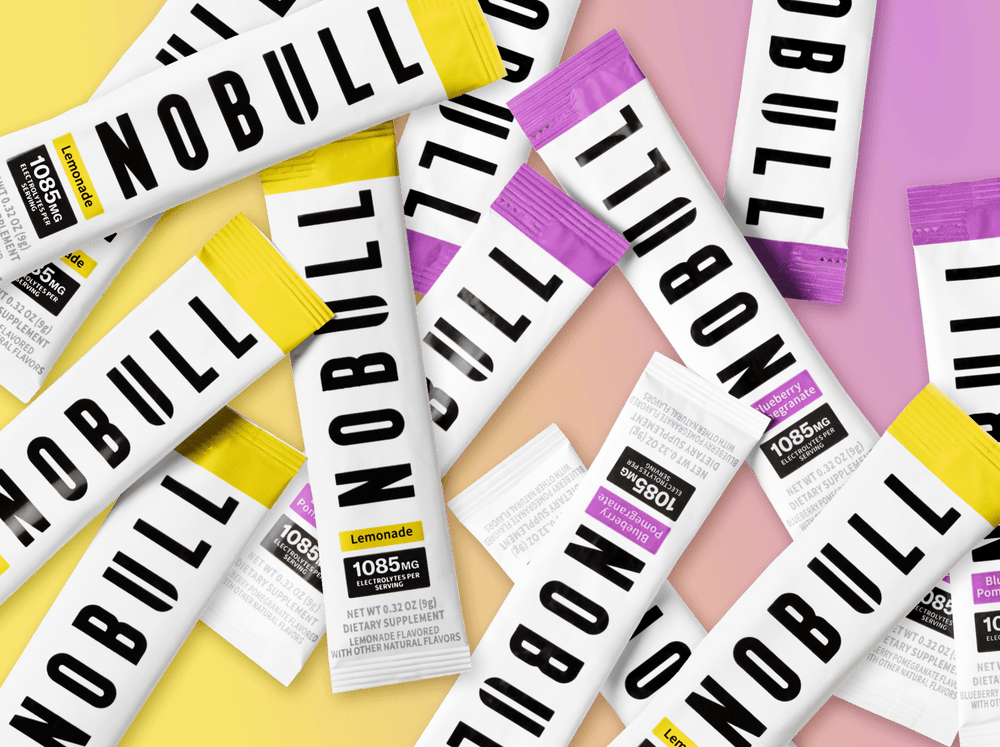 promo - Multiple NOBULL electrolyte packets on a colorful background