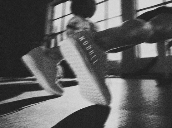 Close-up of a guitar with 'Nobill' branding on a dark background