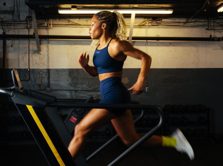 Woman running on a treadmill in an industrial setting