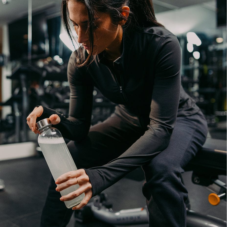 Person in a gym holding a water bottle