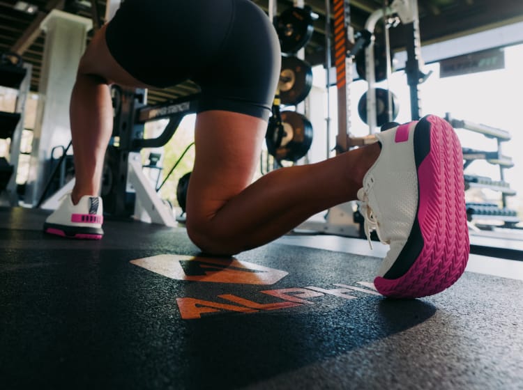 product - lady lunging wearing Pink Glo Outwork Flex Shoes