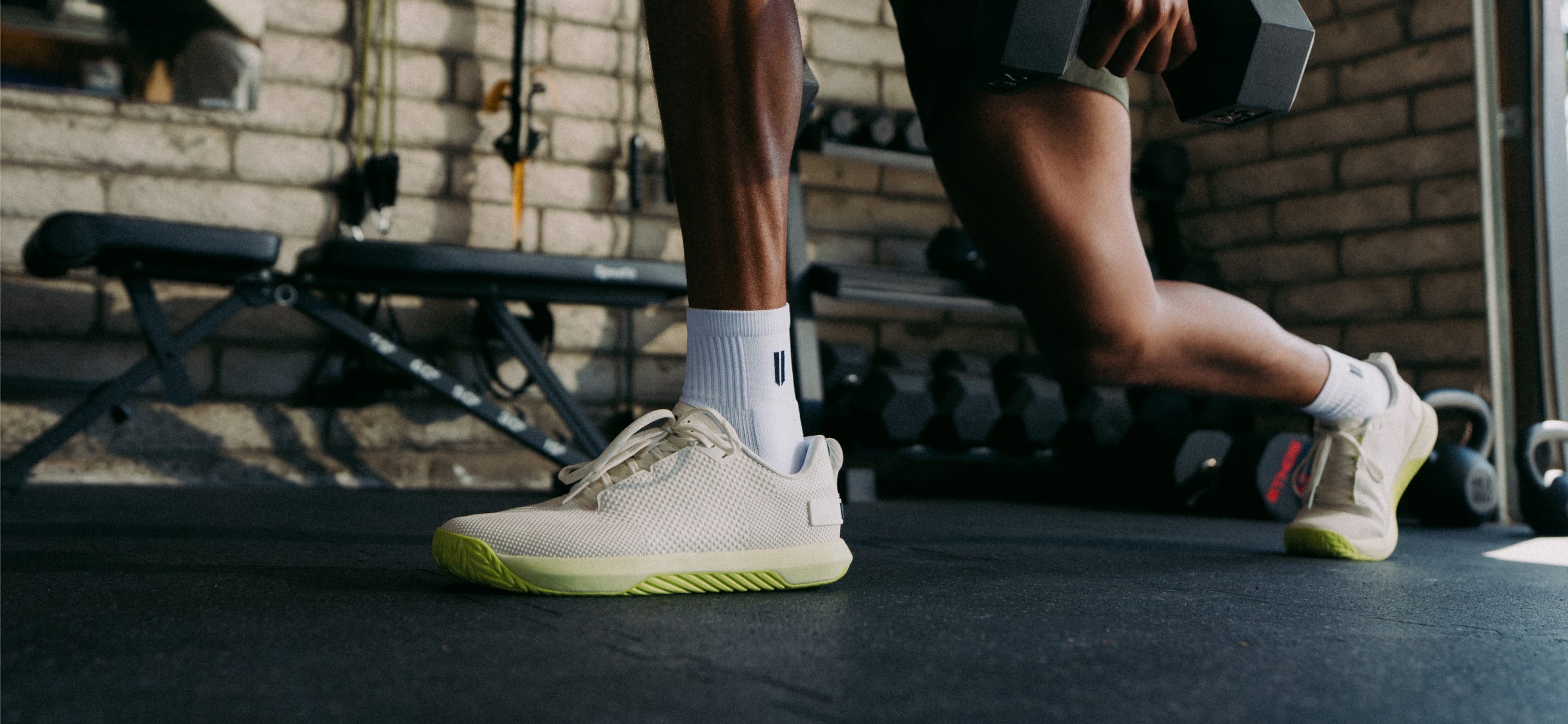 promo - Person wearing white outwork flex shoes with zest sole in a gym setting