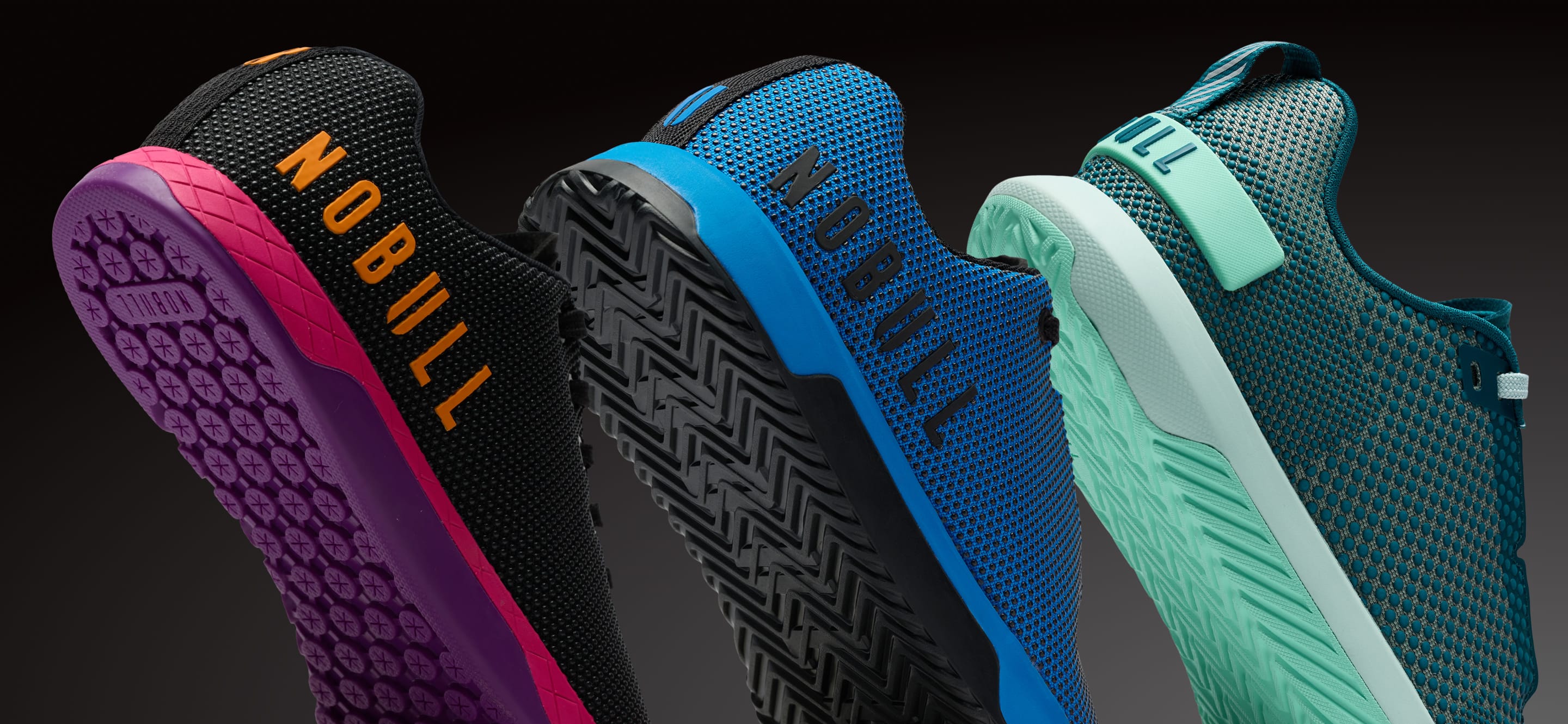 product - Three athletic shoes shown from the side and back against a dark gradient background, featuring the NOBULL brand name on the sides. The shoes display vibrant colorways: black with magenta and orange, blue with black and light blue, and teal with mint green and white.