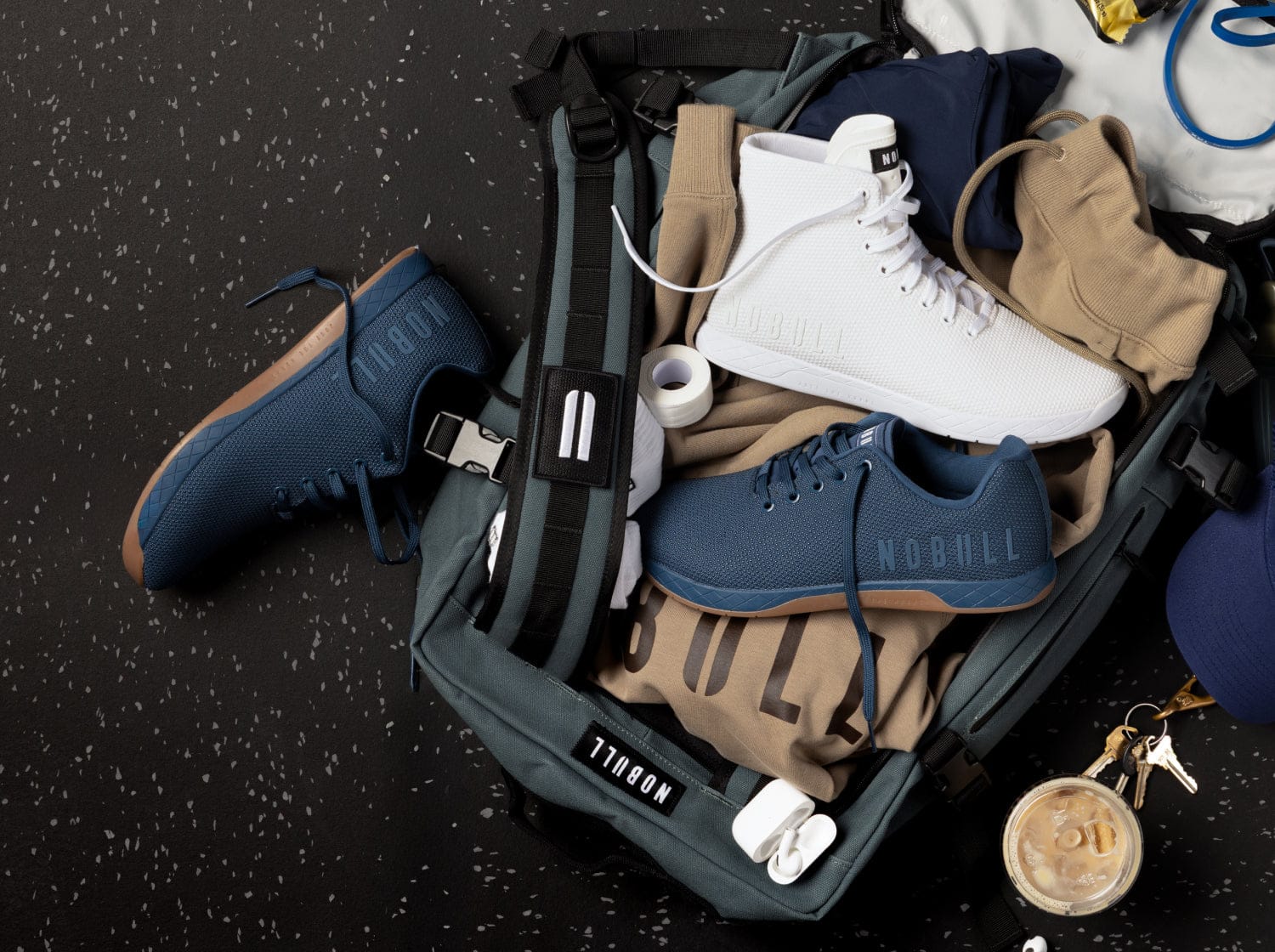 Open suitcase with clothes and shoes on a dark surface