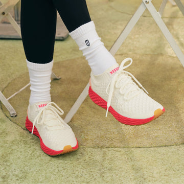 Close up shot of woman wearing the classic white punch allday knit