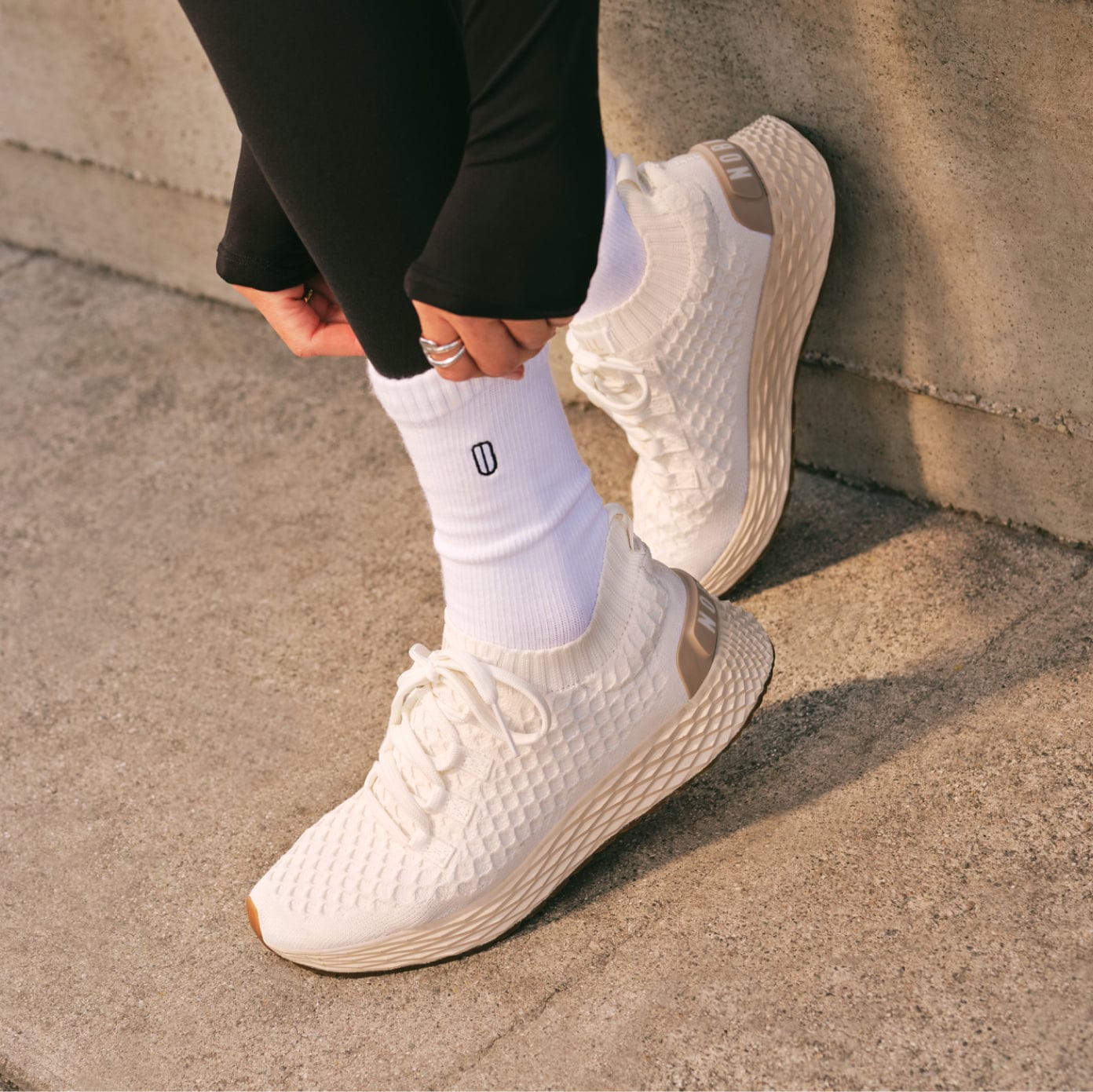 woman wearing the classic white lunar allday knit shoes