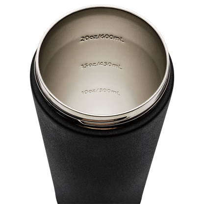 Close-up of a black insulated tumbler with measurement markings on the lid.