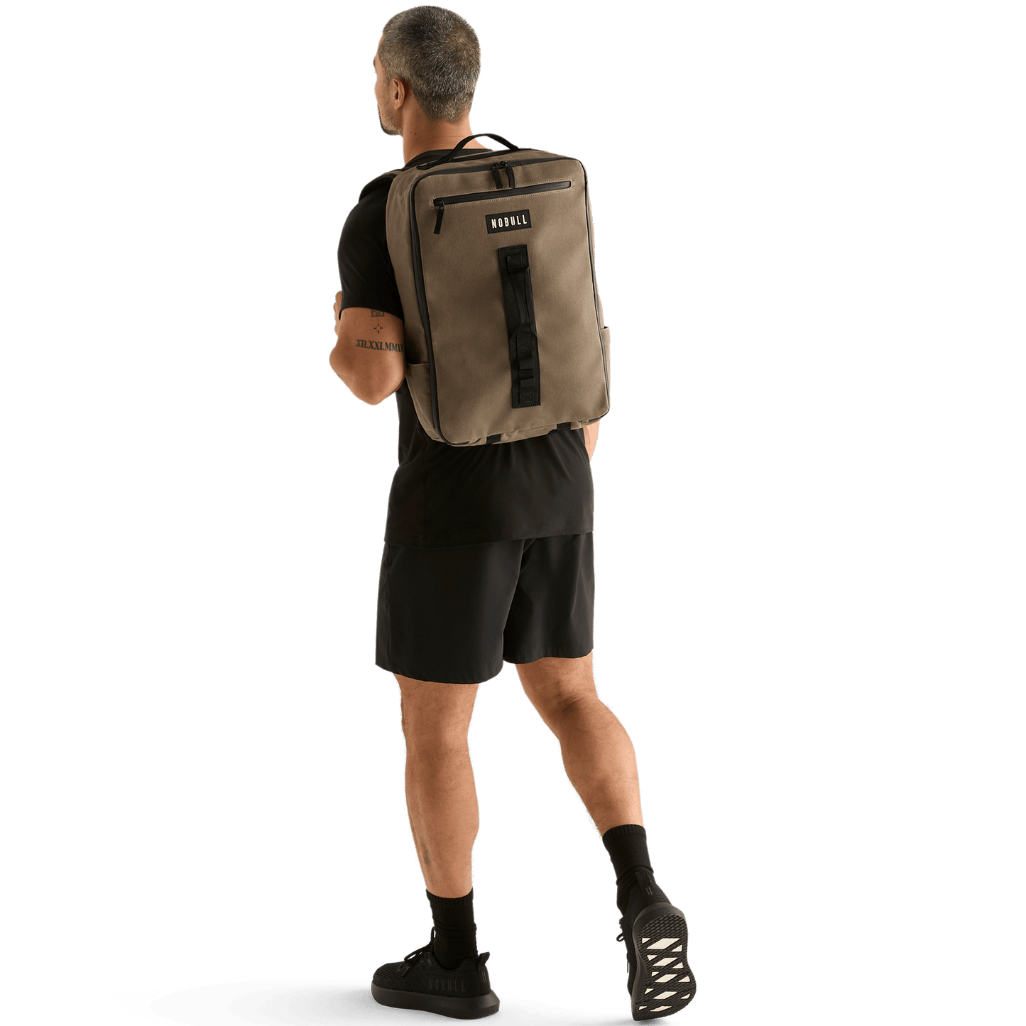 Man Wearing NOBULL Fallen Rock Waxed Backpack On Body Shot.