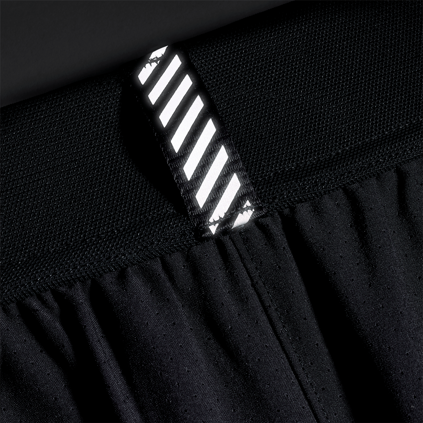 Men's Black NOBULL Drive Short 6" Reflective Tab Detail Angle.