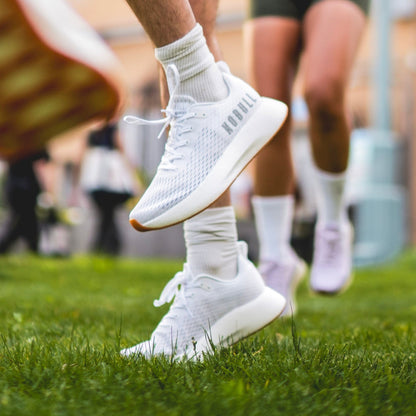 Men's White Journey Shoe On Body Angle.