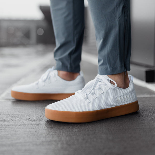 Men's White Recs Knit Shoes On Body Angle.