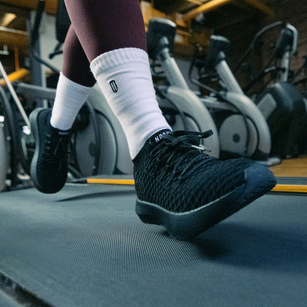 Women's Triple Black Drive Knit Shoe On Body Angle.