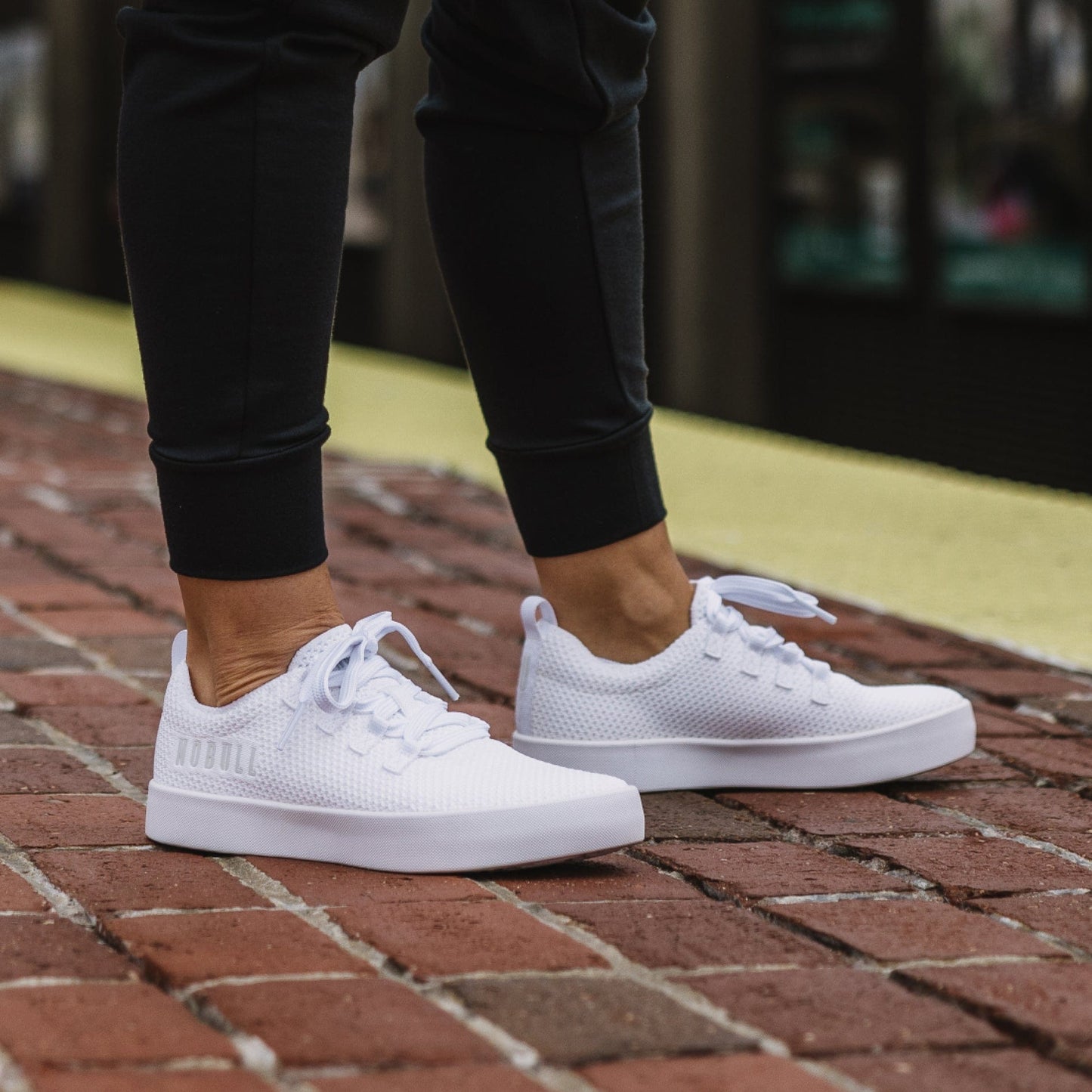 Women's White Recs Knit Shoes On Body Angle.