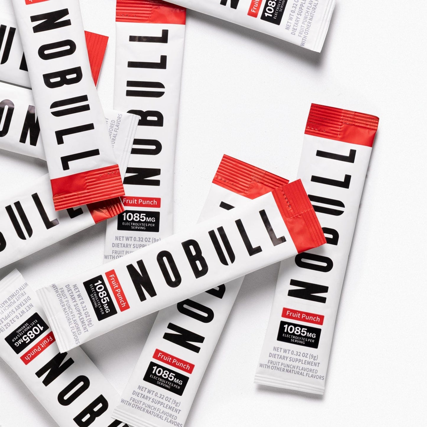 Multiple fruit punch electrolyte packets on a white background