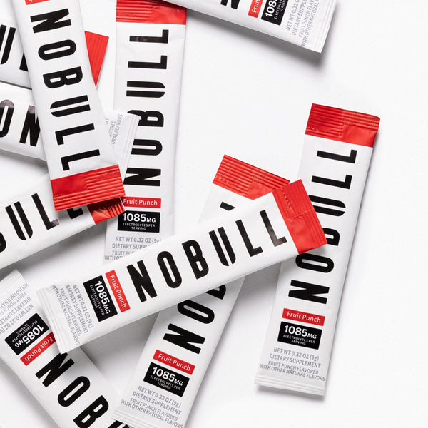 Multiple fruit punch electrolyte packets on a white background