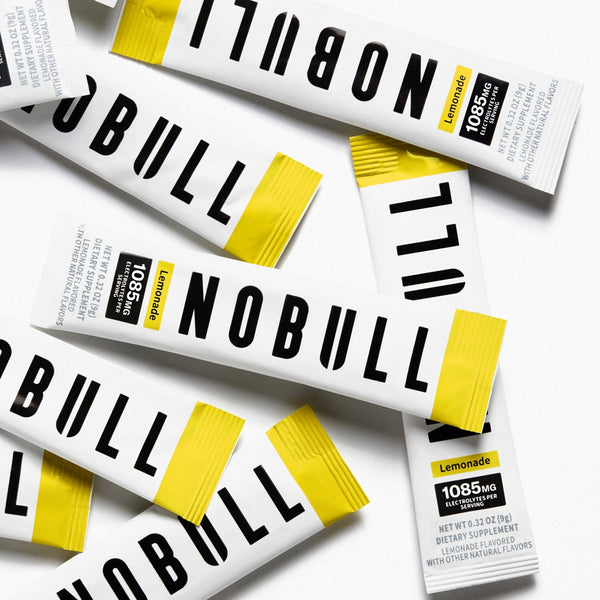 Multiple lemonade electrolyte packets on a white background