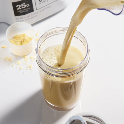 Vanilla Plant protein shake being poured into a glass