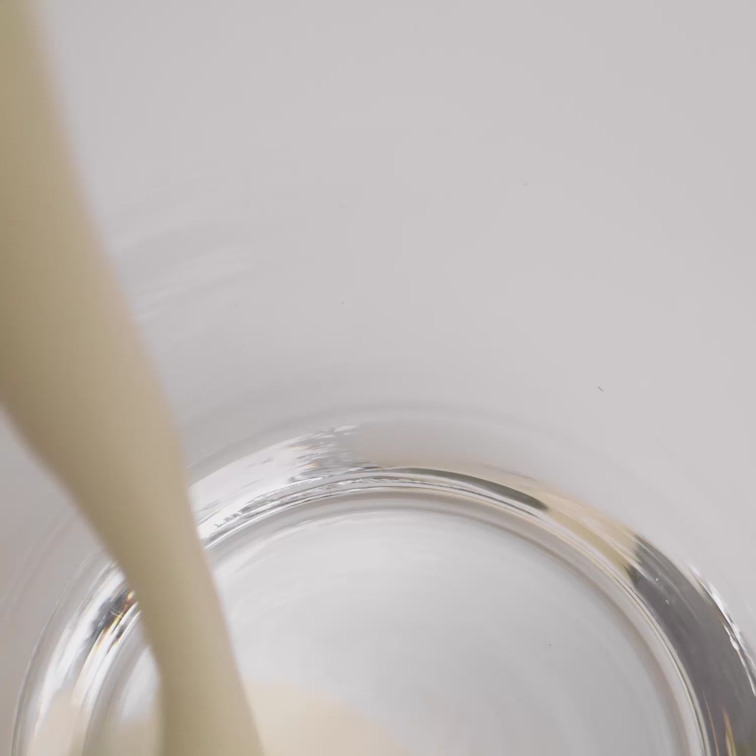 Vanilla plant protein shake being poured into a glass