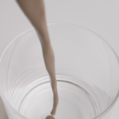 chocolate whey protein shake being poured into a glass