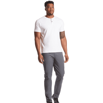 Man wearing a white polo shirt and gray pants on a transparent background